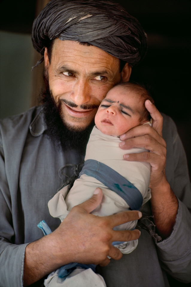 AFGHN-13293, Afghanistan, 1984. A man holds a baby.